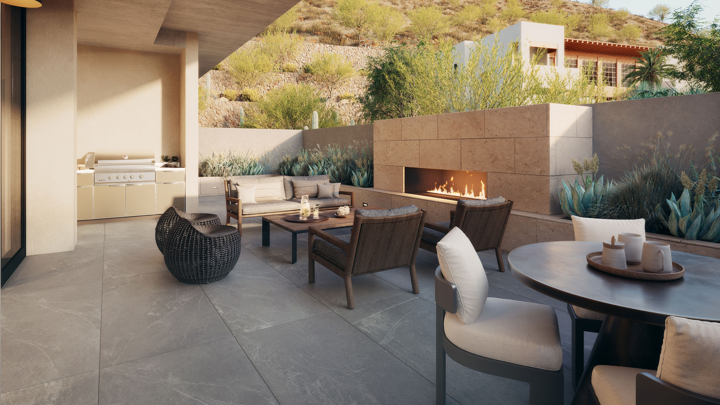 Expansive terrace features an outdoor kitchen, fireplace and planter wall.